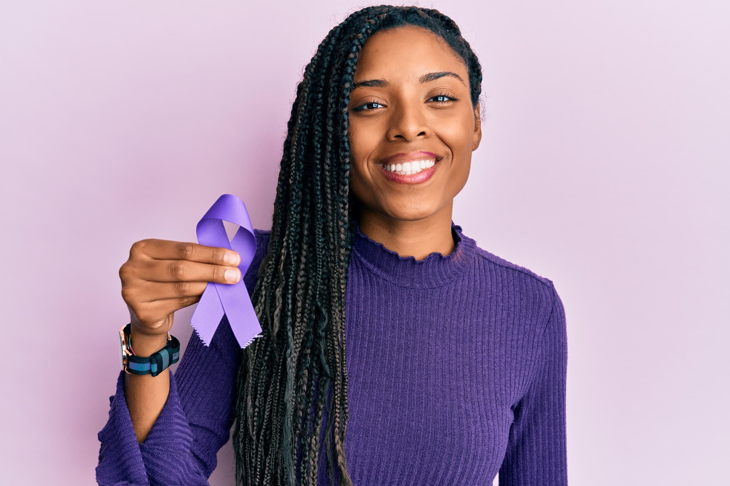 Woman holding a purple fibromyalgia awareness ribbon