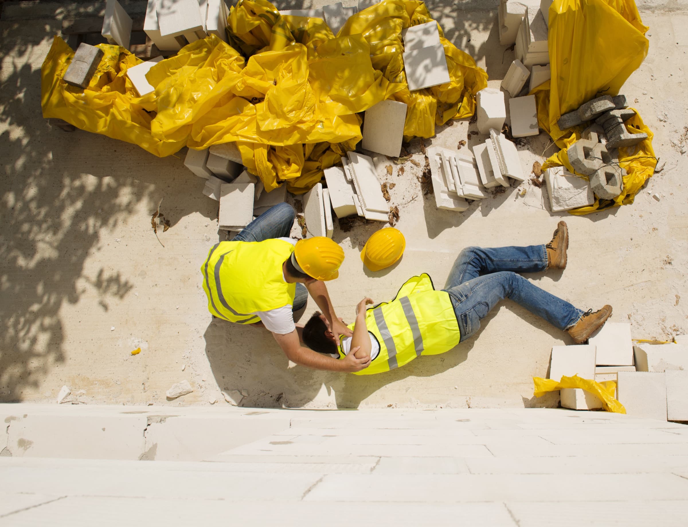 Injured worker being helped after a fall